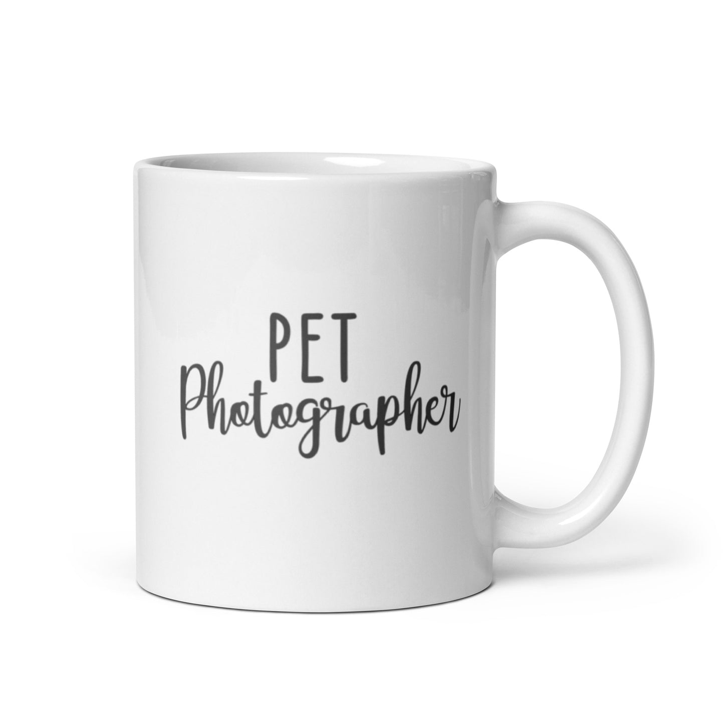 White Mug that says Pet Photographer in black letters. Pet is in print and photographer is in cursive.